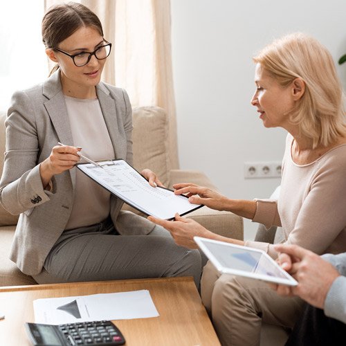 Two women reviewing printed reports