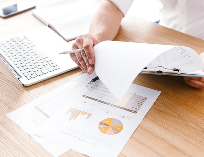 Person analyzing paper documents